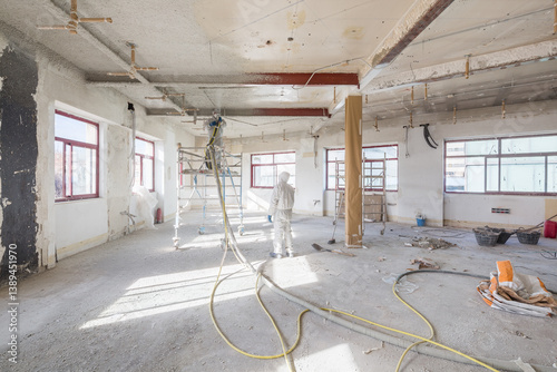 Renovation Site with Workers and Equipment Under Bright Light