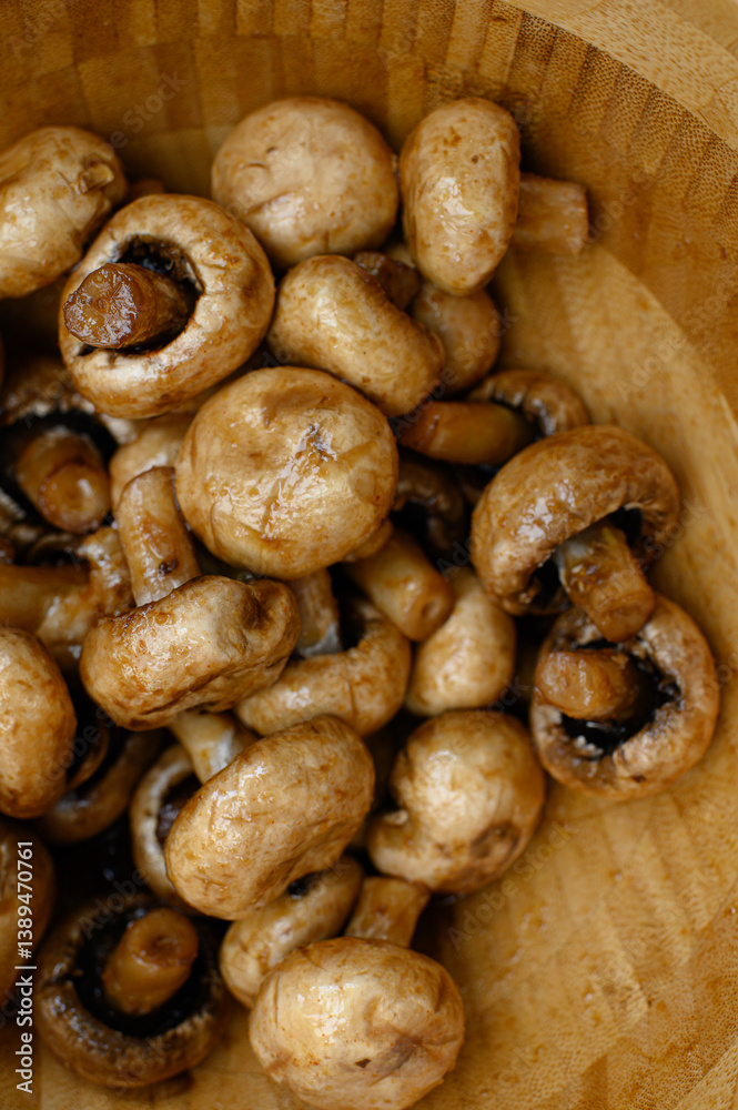 Marinated champignon mushrooms in a wooden bowl, ready for grilling. Fresh, rustic ingredients for outdoor BBQ. Natural light, healthy plant-based cooking scene. Marinated champignon mushrooms in a wooden bowl, ready for grilling. Fresh, rustic ingredients for outdoor BBQ. Natural light, healthy plant-based cooking scene.