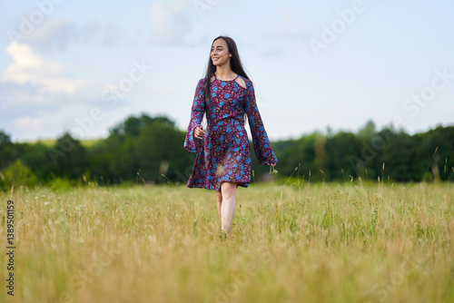 Obraz na płótnie Woman in floral dress standing in summer meadow......... w salonie