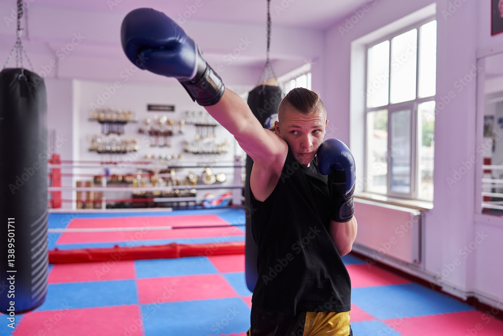 Boxer practicing punch in gym.........