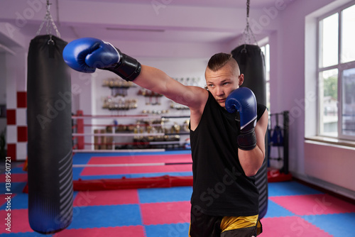 Obraz na płótnie Boxer practicing punch in gym......... w salonie