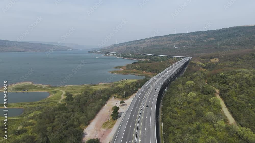 The M6 motorway Expressway Nakhon Ratchasima Province - Bang Pa-in. Lam Ta Khong River and Mountain. Drone shot of scenic landscape rural place traffic. Nakhon Ratchasima Thailand. Motorway Korat The M6 motorway Expressway Nakhon Ratchasima Province - Bang Pa-in. Lam Ta Khong River and Mountain. Drone shot of scenic landscape rural place traffic. Nakhon Ratchasima Thailand. Motorway Korat