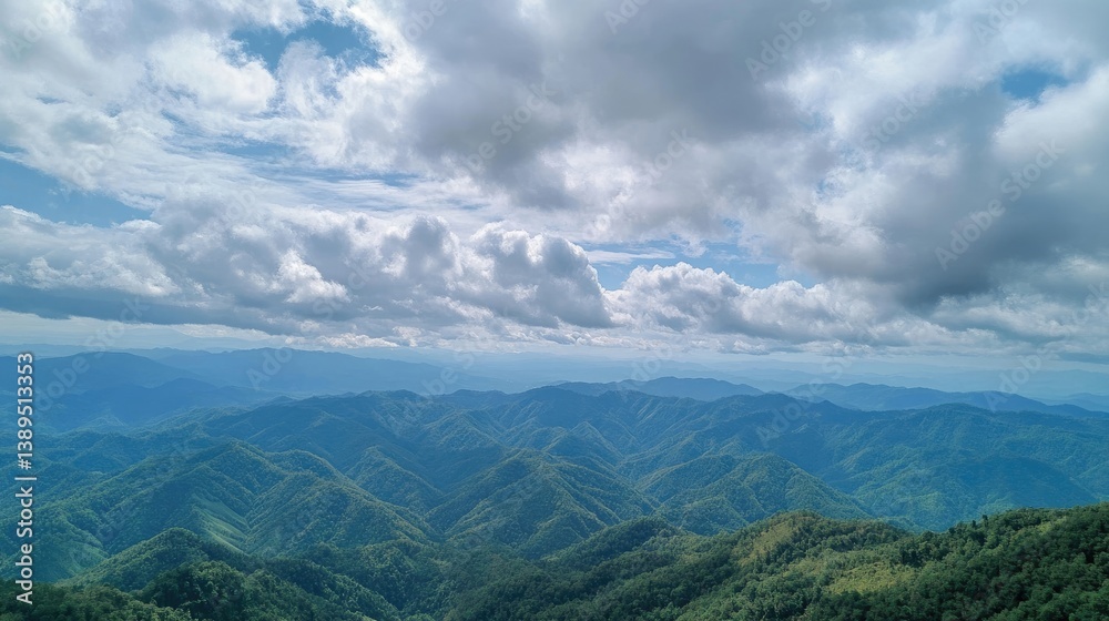 Obraz premium Scenic view of mountains with dramatic cloudy sky