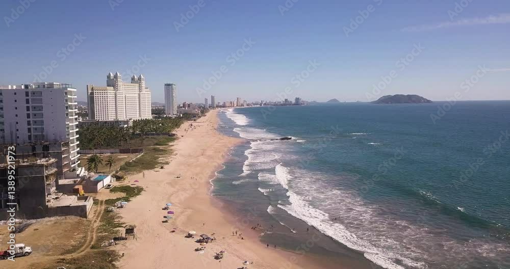 Aerial over golden sand beach with toursits in tropical resort town, Mazatlán, Mexico Aerial over golden sand beach with toursits in tropical resort town, Mazatlán, Mexico