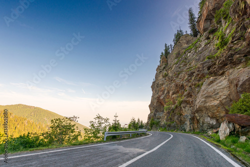 Obraz na płótnie transfagarasan road curve near steep rocky slope. great outdoors of fagaras mountain ridge of romania in summer. dangerous alpine pass in carpathians. popular travel destination of europe w salonie
