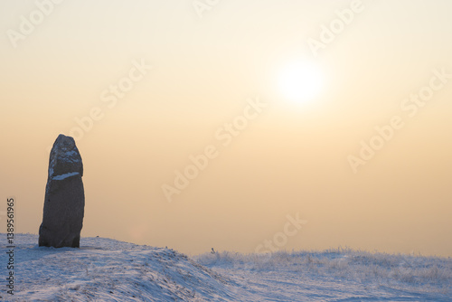 Obraz na płótnie Stone stele on a snowy mountain slope. Fragment of the memorial complex on Mount Samokhval, dedicated to those who died defending the Fatherland. Abakan, Republic of Khakassia, Siberia, Russia. w salonie