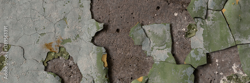 Obraz na płótnie Peeling paint on the wall. Panorama of a concrete wall with old cracked flaking paint. Weathered rough painted surface with patterns of cracks and peeling. Wide panoramic grunge texture for background w salonie
