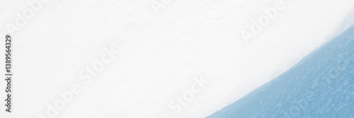 Obraz na płótnie Wide panoramic winter background with snowy ground. Natural snow texture. Wind sculpted patterns on snow surface. Closeup top view with copy space. w salonie