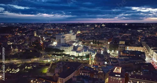 Establishing shot drone flying of historical monument to Vittorio Emanuele II in Rome on Venice Square at night. Downtown Rome, Italy