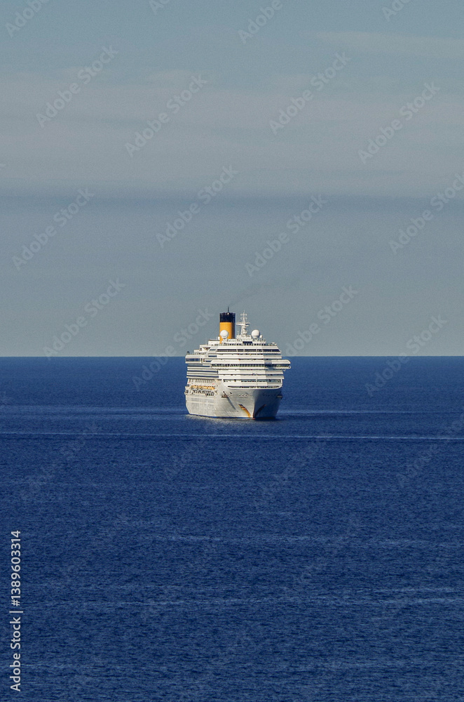 Mega family cruiseship cruise ship liner Fortuna anchored offshore of Civitavecchia Rome, Italy before reactived after Covid pandemic with other vessels in port and coastline