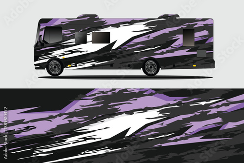 Abstractly designed RV with bold purple and black graphics, parked on a neutral background