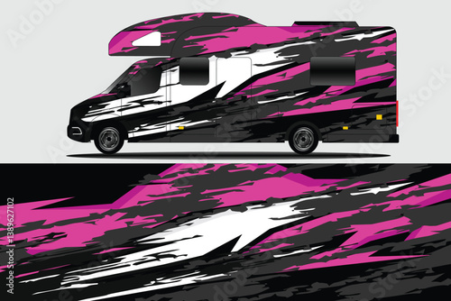 Modern camper van with vibrant pink and black abstract design parked against a neutral background
