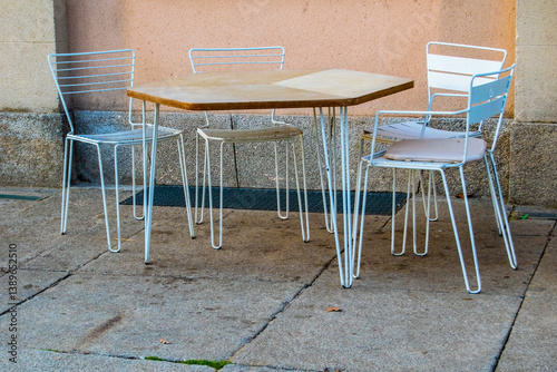 terrace tables and chairs against a wall