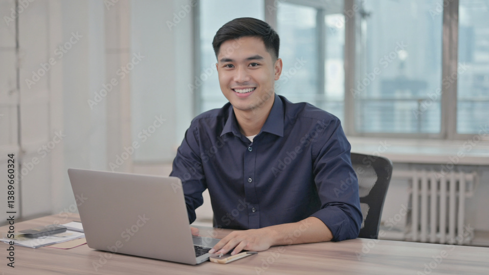 A person working on their computer at a desk