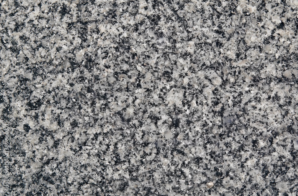 A natural granite stone texture background with a coarse, speckled surface. Mixed tones of gray, white, and black create a rugged and earthy appearance. Ideal for natural design themes A natural granite stone texture background with a coarse, speckled surface. Mixed tones of gray, white, and black create a rugged and earthy appearance. Ideal for natural design themes