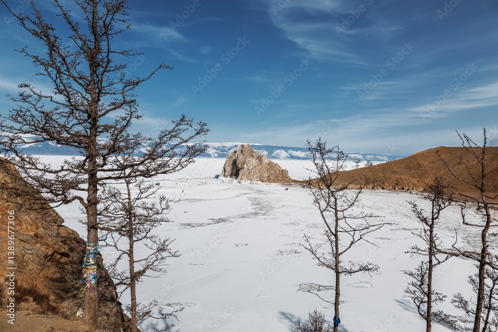 Top view of Shamanka Rock and Cape Burkhan of Olkhon Island on Lake Baikal on a winter sunny day. Irkutsk region, Russia