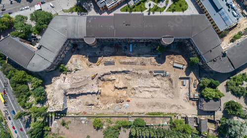 Drone aerial top view to the land plot on which the construction process is taking place on a sunny summer day. Building former factory Arsenal. Kyiv Kiev capital of Ukraine