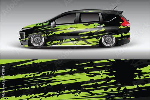 Sleek modified car with vibrant green and black abstract design parked against a gradient backdrop