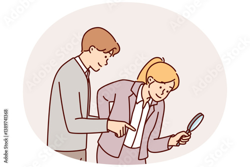 Man and woman working as detectives use magnifying glass during investigation to find evidence