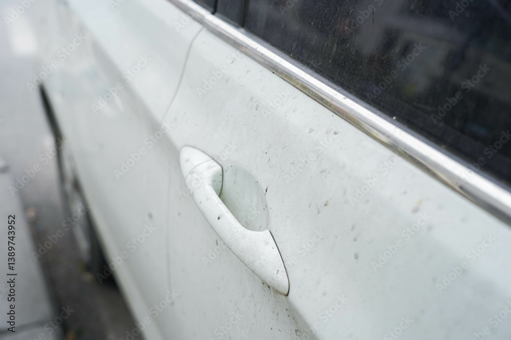 Close-up of dusty car door handle, impact of dirt and salt accumulation on vehicle aesthetics and the importance of regular maintenance. Clean car door handle, selective focus.