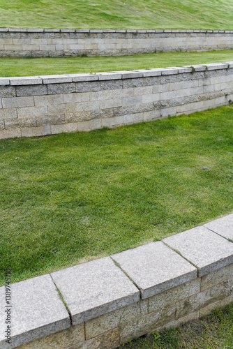 Concrete curb along and curve on the grass lawn that make to the boundary and step for rain the water at the park