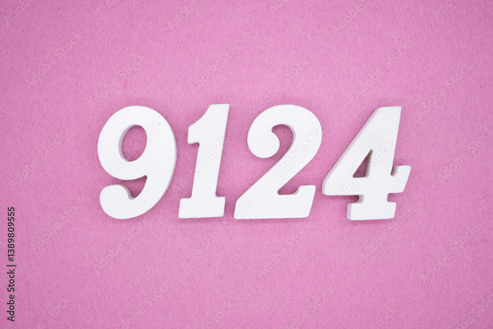 The numbers are made of white painted wood and placed on a pink paper background. The numbers are made of white painted wood and placed on a pink paper background.