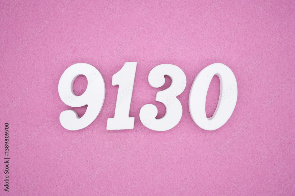The numbers are made of white painted wood and placed on a pink paper background. The numbers are made of white painted wood and placed on a pink paper background.