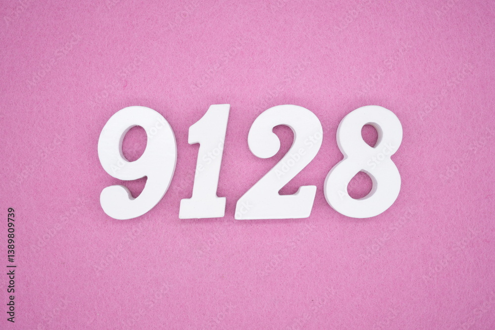 The numbers are made of white painted wood and placed on a pink paper background. The numbers are made of white painted wood and placed on a pink paper background.