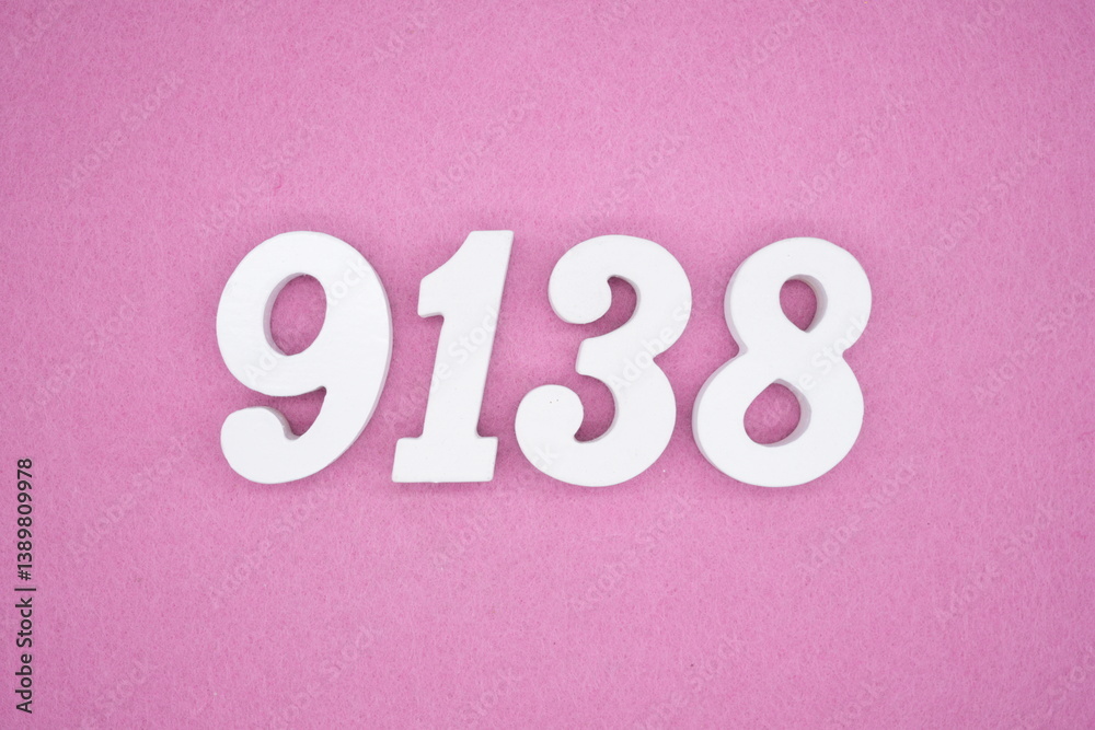 The numbers are made of white painted wood and placed on a pink paper background. The numbers are made of white painted wood and placed on a pink paper background.