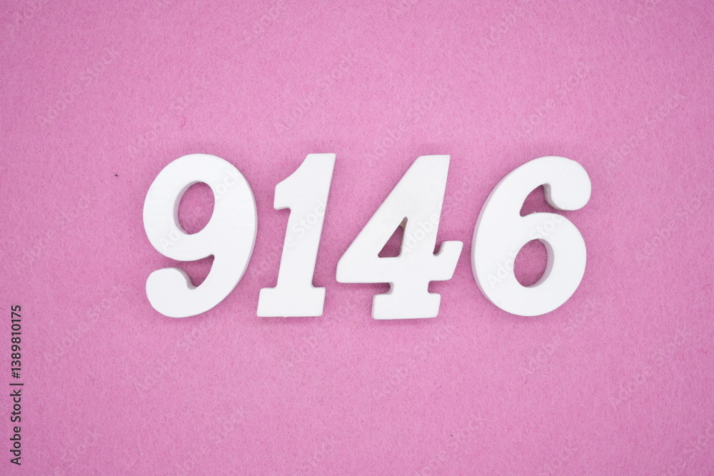 The numbers are made of white painted wood and placed on a pink paper background. The numbers are made of white painted wood and placed on a pink paper background.