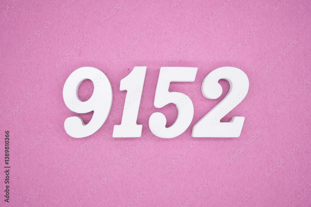 The numbers are made of white painted wood and placed on a pink paper background. The numbers are made of white painted wood and placed on a pink paper background.