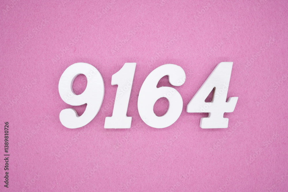 The numbers are made of white painted wood and placed on a pink paper background. The numbers are made of white painted wood and placed on a pink paper background.