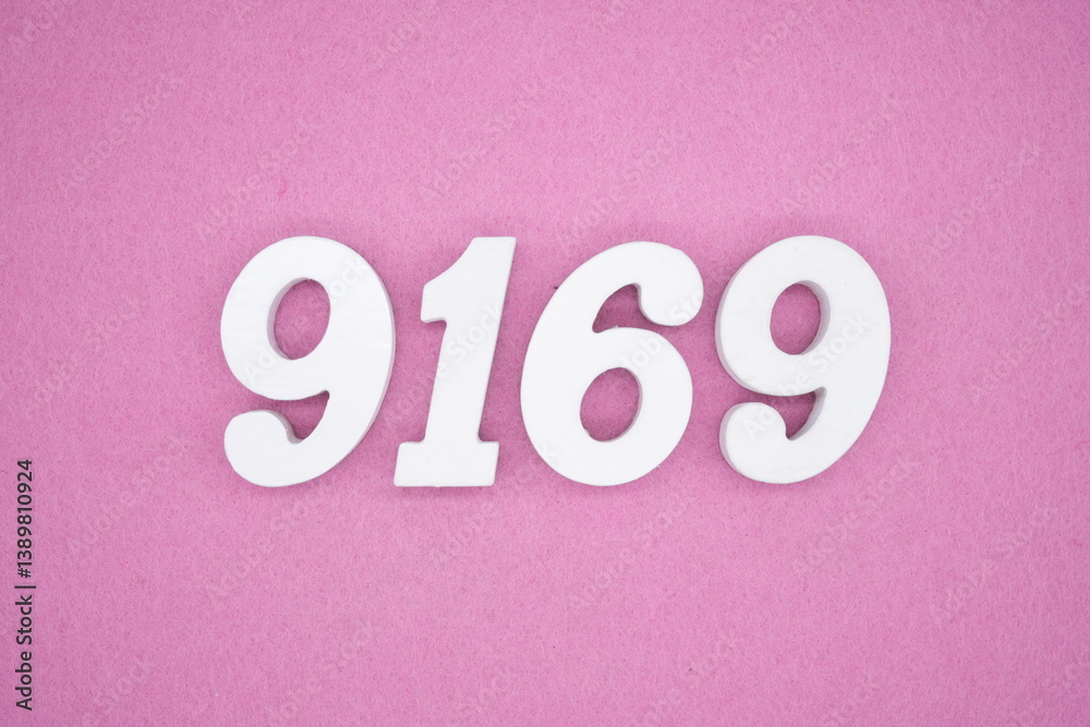 The numbers are made of white painted wood and placed on a pink paper background. The numbers are made of white painted wood and placed on a pink paper background.