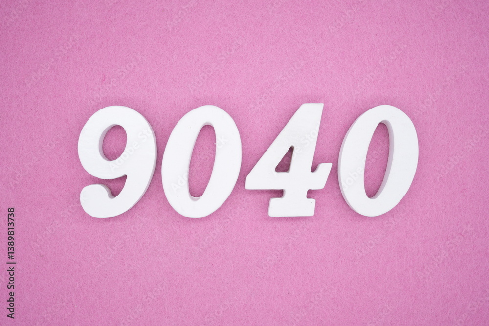 The numbers are made of white painted wood and placed on a pink paper background.