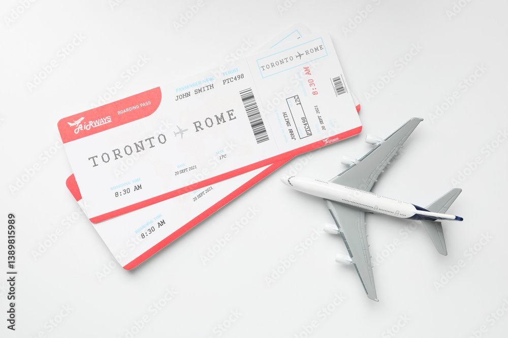 Travel agency. Flight tickets and plane model on light background, flat lay