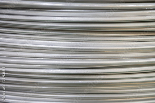 Wallpaper Mural Close-up of coiled aluminum wires, highlighting their smooth surface and layered overlapping pattern, captured in soft lighting.. Torontodigital.ca