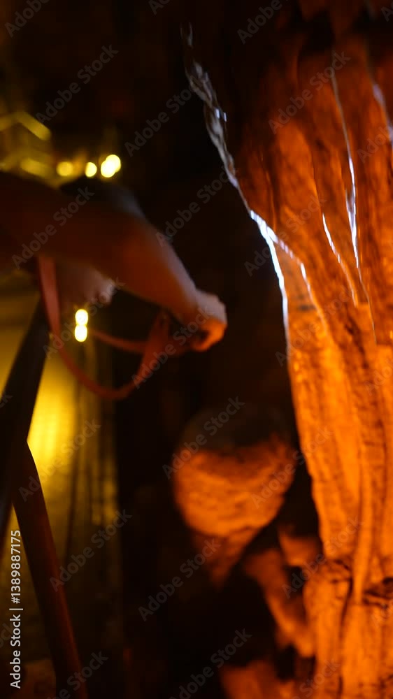 Exploring stunning cave formations with a flashlight for illumination on our adventure Exploring stunning cave formations with a flashlight for illumination on our adventure