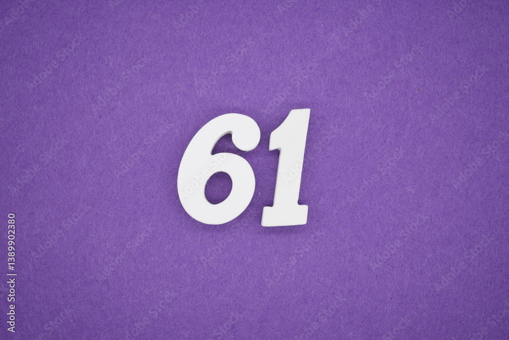 The numbers are made of white painted wood placed on a purple paper background. The numbers are made of white painted wood placed on a purple paper background.