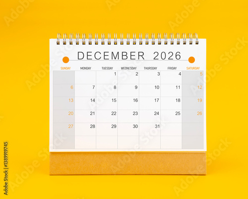 December 2026 desk calendar on yellow background, Front view.