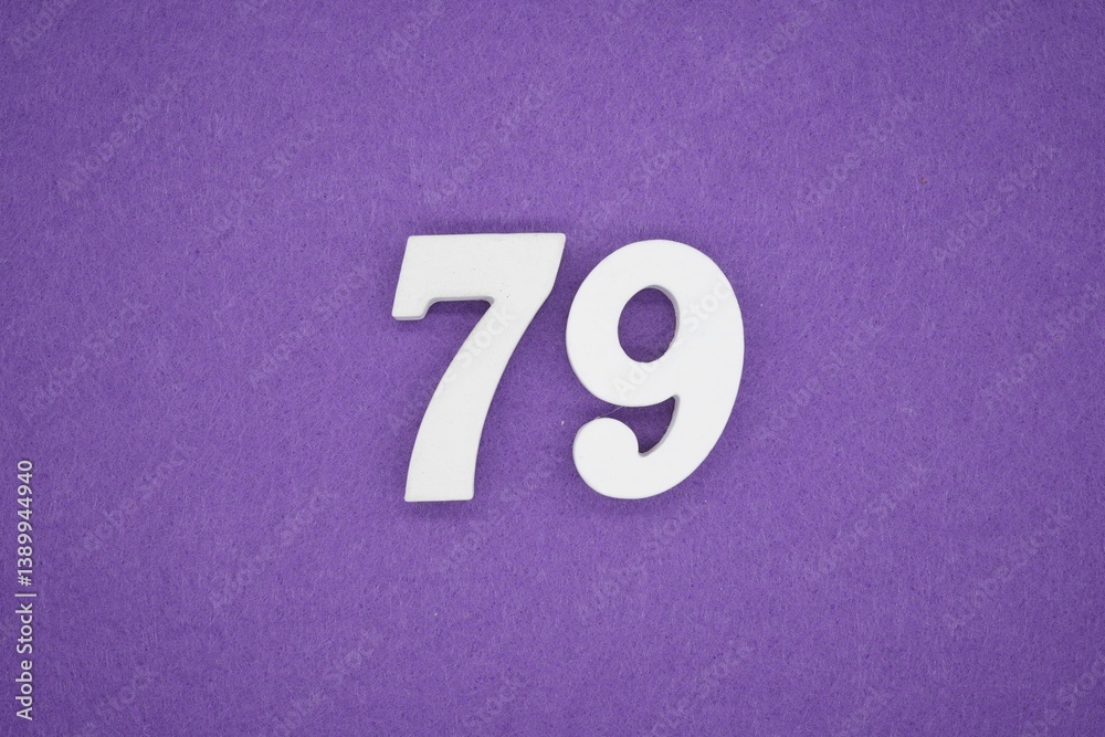 The numbers are made of white painted wood placed on a purple paper background. The numbers are made of white painted wood placed on a purple paper background.