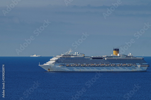 Mega family cruiseship cruise ship liner Pacifica anchored offshore of Civitavecchia Rome, Italy before reactived after Covid pandemic with other vessels in port and coastline