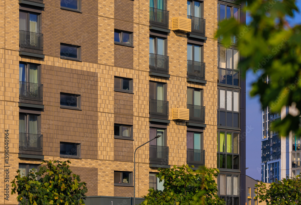 Fototapeta premium City view on a sunny day. Modern buildings, walls and windows. 