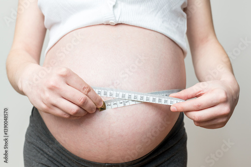 belly size during pregnancy, a woman measures her belly circumference in the ninth month of pregnancy