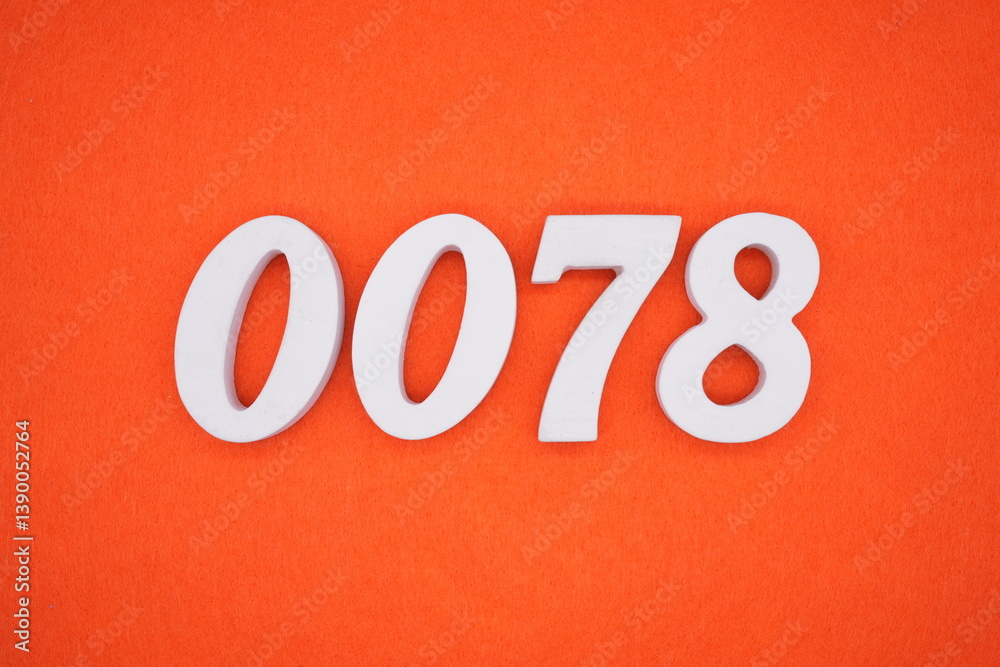 The numbers are made of white painted wood placed on an orange paper background. The numbers are made of white painted wood placed on an orange paper background.