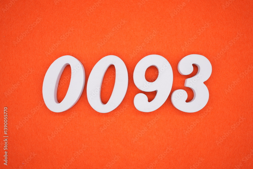 The numbers are made of white painted wood placed on an orange paper background.