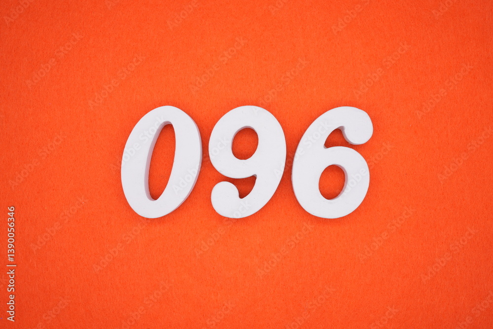 The numbers are made of white painted wood placed on an orange paper background. The numbers are made of white painted wood placed on an orange paper background.