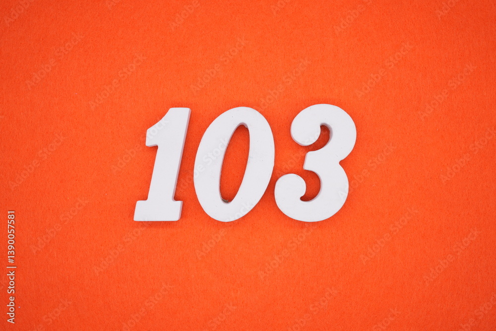 The numbers are made of white painted wood placed on an orange paper background. The numbers are made of white painted wood placed on an orange paper background.