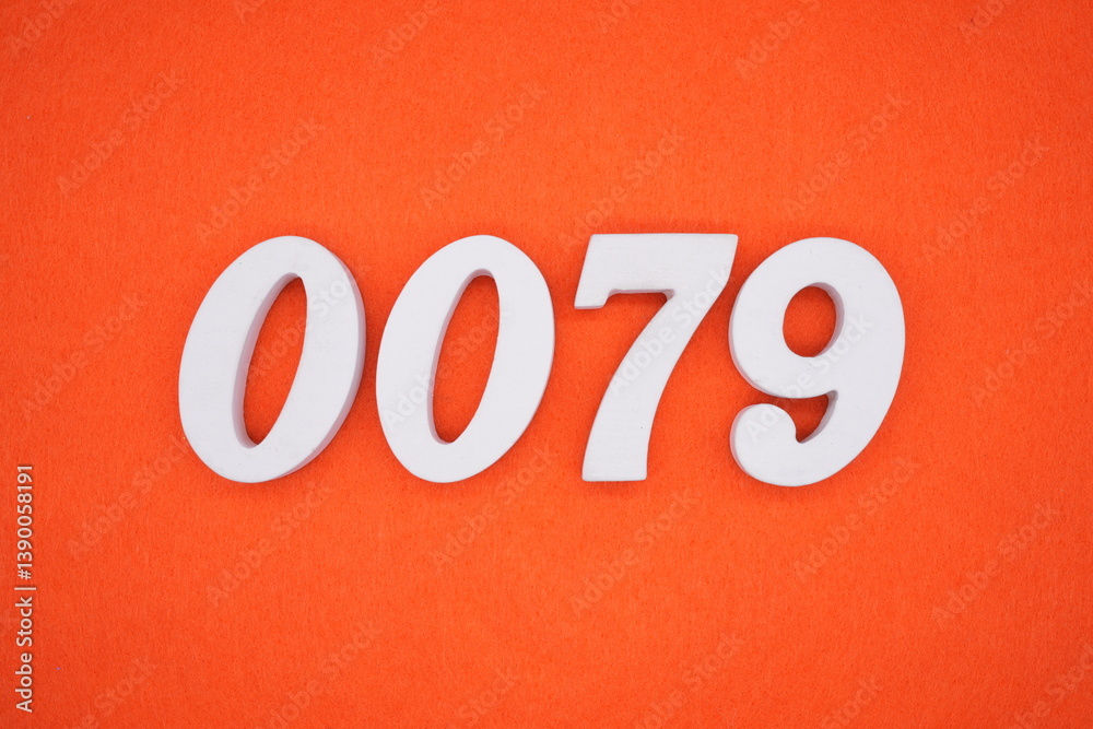 The numbers are made of white painted wood placed on an orange paper background. The numbers are made of white painted wood placed on an orange paper background.