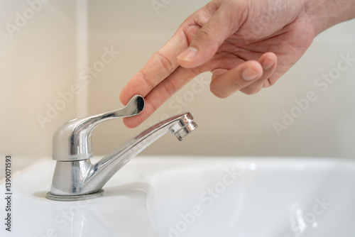 Save water. Volunteer keeps turning off the running water in the bathroom to protect environment. Greening planet, reduce global warming, Save world, life, future, risk energy, crisis , water day. photo