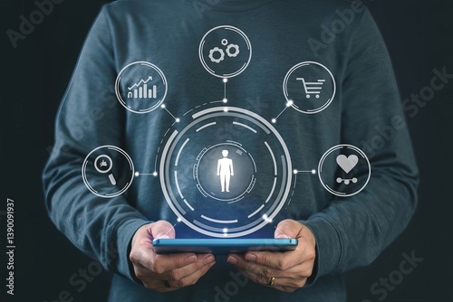 A man holds a tablet with a virtual hologram of digital marketing icons and a human icon inside it, a business concept for customer profile management or social media targeting and basic data analysis